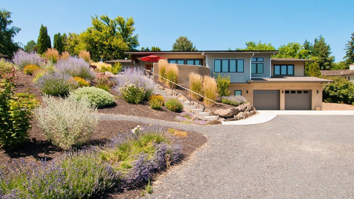 Eco home exterior with lush garden landscaping