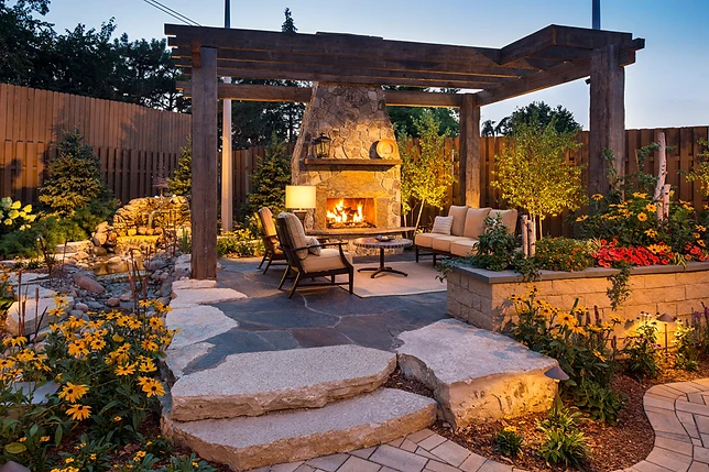 Timber pergola with stone fireplace and garden