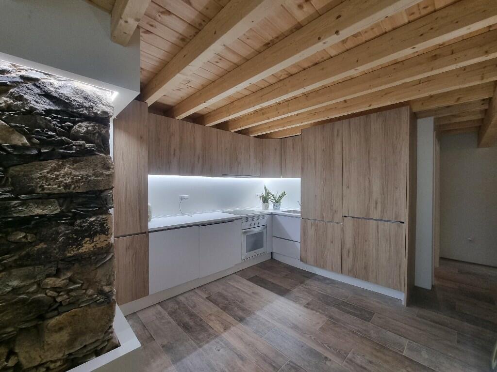 Stone wall integrated into modern kitchen